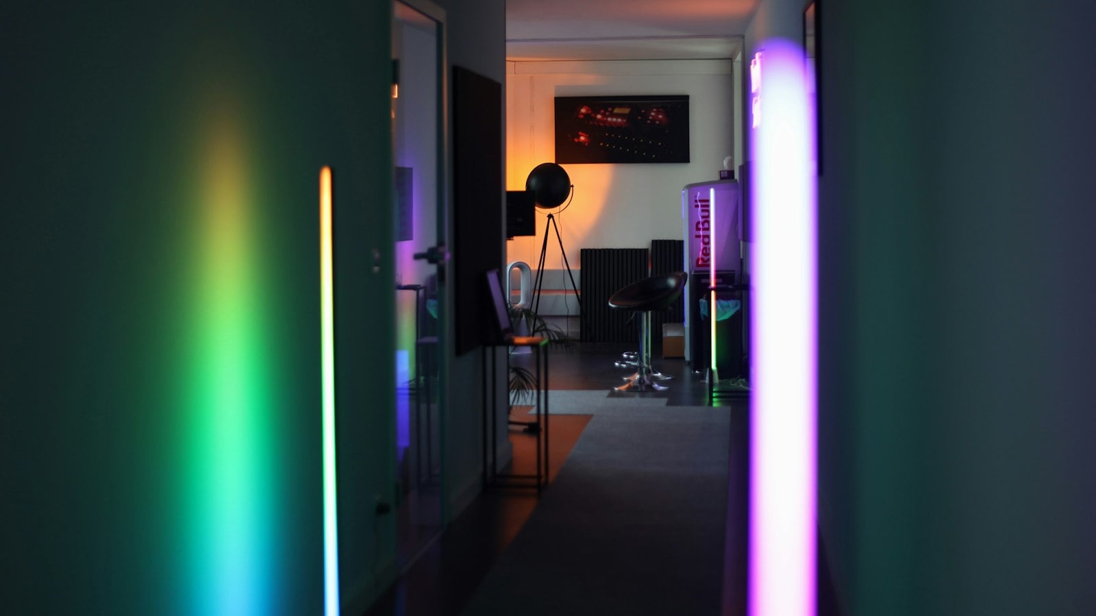 Color-changing LED light bars glowing along a hallway (photo: Mustafa Sheikhmouss / Unsplash)