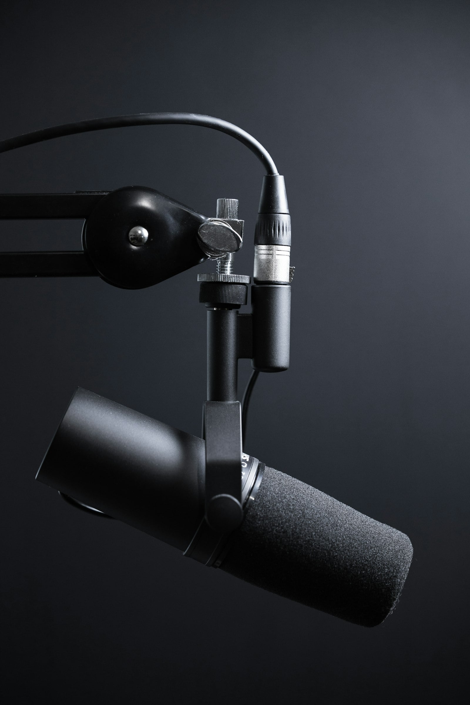 Podcast microphone on a boom arm (photo: Jukka Aalho / Unsplash)